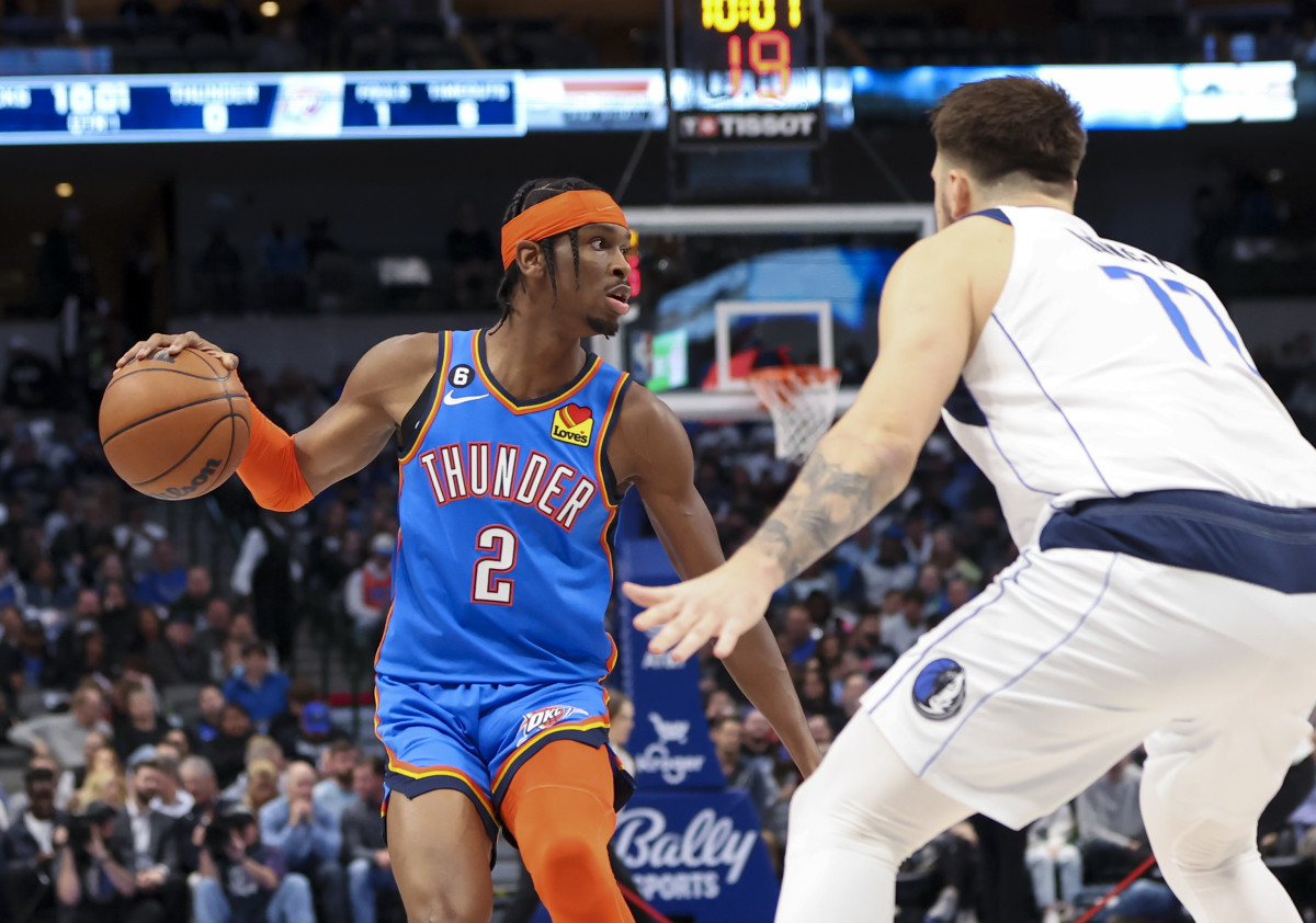 Dec 12, 2022; Dallas, Texas, USA; Oklahoma City Thunder guard Shai Gilgeous-Alexander (2) dribbles as Dallas Mavericks guard Luka Doncic (77) defends during the first quarter at American Airlines Center. Mandatory Credit: Kevin Jairaj-USA TODAY Sports